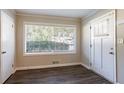 Bright entryway with large window, white door, and dark wood floors at 2775 Tilson Rd, Decatur, GA 30032