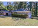 Side view of ranch home showcasing landscaping and yard at 2775 Tilson Rd, Decatur, GA 30032