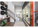 Bright foyer with hardwood floors, staircase, and mirrors at 320 Lavender Ln, Holly Springs, GA 30115