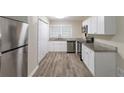 Renovated kitchen, featuring stainless steel appliances and granite countertops at 6168 Ellis St, Douglasville, GA 30134