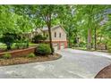 Exterior view of the home with a large driveway and garage at 721 Smithstone Se Rd, Marietta, GA 30067