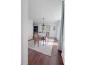 Bright dining room with hardwood floors, chandelier, and decorative plates at 4424 Lower Fayetteville Rd, Sharpsburg, GA 30277