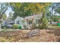 Charming light green house with a well-maintained lawn and a bench at 1618 Belmont Sw Ave, Atlanta, GA 30310