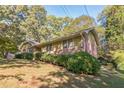 Ranch style home situated on a sloping lot with lush landscaping at 1996 Walton Woods Cir, Tucker, GA 30084