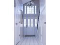 Bright entryway with tiled floor, white doors, and large window at 1563 Poplarwood Nw Ln, Lawrenceville, GA 30043