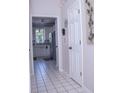 Hallway with tile floor, white doors, and kitchen view at 1563 Poplarwood Nw Ln, Lawrenceville, GA 30043