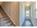 Modern staircase with hardwood flooring and neutral walls at 211 Depot Landing Rd, Auburn, GA 30011