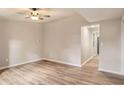 Living room with light gray walls, wood-look floors, and ceiling fan at 315 Pine Cir, Bowdon, GA 30108