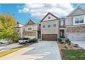 Attractive townhome with stone accents, two-car garage, and well-maintained landscaping at 7545 Roseberry Way, Lithonia, GA 30038