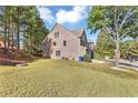 Side view of two story home showcasing landscaping at 5401 Stone Cove Sw Dr, Atlanta, GA 30331
