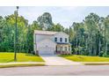 Two-story house with white siding, stone accents, and a two-car garage at 134 Henley St, Canton, GA 30114
