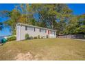 Newly renovated ranch home with a red door and landscaped yard at 6230 Kensington Ct, Austell, GA 30106