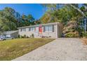 Ranch home with a newly paved driveway and mature trees at 6230 Kensington Ct, Austell, GA 30106