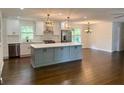 Modern kitchen with gray island and hardwood floors at 2534 Creekview Sw Dr, Marietta, GA 30008