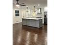 Modern kitchen with gray island and hardwood floors at 2534 Creekview Sw Dr, Marietta, GA 30008