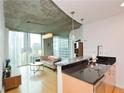 Open kitchen with granite countertops and stainless steel appliances at 400 W Peachtree Nw St # 1713, Atlanta, GA 30308