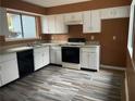 Kitchen with white cabinets, wood-look floors and appliances at 8596 Creekwood Way, Jonesboro, GA 30238