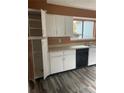 White kitchen cabinets, wood-look vinyl flooring at 8596 Creekwood Way, Jonesboro, GA 30238