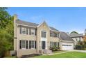 Tan brick two story house with black shutters at 1851 Furlong Run, Lawrenceville, GA 30043