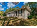 Brick ranch house with attached garage and landscaping at 929 Pine Roc Dr, Stone Mountain, GA 30083