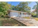 Brick ranch house with attached garage and landscaping at 929 Pine Roc Dr, Stone Mountain, GA 30083