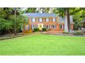 Brick home with gray shutters and yellow door at 801 Hampton Sw Pl, Marietta, GA 30064