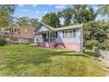 House exterior view, gray siding, pink base, and yard at 2243 Tiger Flowers Nw Dr, Atlanta, GA 30314