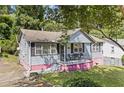 Cute bungalow, gray siding, pink base, and a porch at 2243 Tiger Flowers Nw Dr, Atlanta, GA 30314