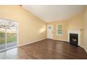 Bright living room featuring hardwood floors, fireplace and sliding glass door at 2003 Glenwood Downs Dr, Decatur, GA 30035