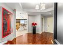 Spacious entryway with hardwood floors and art at 2660 Peachtree Nw Rd # 18G, Atlanta, GA 30305