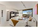 Bright living room with white sofas and city view at 2660 Peachtree Nw Rd # 18G, Atlanta, GA 30305