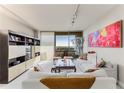 Bright living room with white sofas and city view at 2660 Peachtree Nw Rd # 18G, Atlanta, GA 30305