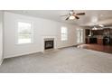 Open living room with kitchen view and fireplace at 4815 Plainsman Cir, Cumming, GA 30028