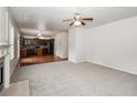 Open living room and kitchen with neutral carpet at 4815 Plainsman Cir, Cumming, GA 30028