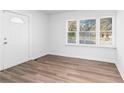 Bright and airy living room with new wood-look flooring and large windows at 1246 Lyle Ave, East Point, GA 30344