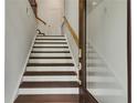 Modern staircase with dark brown wood and white risers at 1090 Battery Park Rd, Decatur, GA 30033