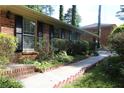 Brick walkway leads to the charming brick home with black shutters at 2501 Henderson Mill Ne Rd, Atlanta, GA 30345