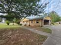 Brick ranch home with yellow accents and driveway at 25 Bryans Dr, Mcdonough, GA 30252
