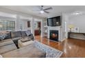 Spacious living room with hardwood floors, fireplace, and sectional sofa at 2397 Sardis Chase Ct, Buford, GA 30519
