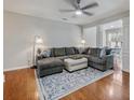 Open living area with hardwood floors, sectional sofa, and a large area rug at 2397 Sardis Chase Ct, Buford, GA 30519