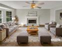 Virtually staged living room with fireplace, hardwood floors, and ample seating at 120 Birch Creek Cir, Mcdonough, GA 30253
