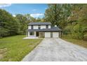 Two-story house with a two-car garage and stone accents at 5271 Kelleys Mill Cir, Stone Mountain, GA 30088