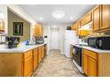 Bright kitchen featuring wood cabinets and tiled floor at 10654 Village Lndg, Jonesboro, GA 30238