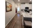 Modern kitchen with white cabinets, hardwood floors, and an island at 1702 Villageside Ct, Lawrenceville, GA 30043