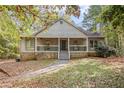House exterior showcasing a wraparound porch and landscaping at 175 Carriage Gate Dr, Sharpsburg, GA 30277