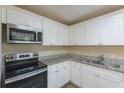 Updated kitchen with white shaker cabinets and granite countertops at 2465 Timberly Se Dr, Marietta, GA 30060