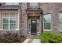 Elegant front door entrance with brick detailing and landscaping at 4203 Shandi Cv, Hoschton, GA 30548