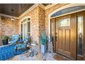 Inviting front porch with stone flooring and comfortable seating at 145 Oak Forest Dr, Oxford, GA 30054