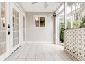 Bright screened porch with tile flooring and French doors at 346 Carpenter Dr # 16, Sandy Springs, GA 30328