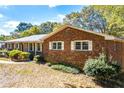 Brick ranch house showcasing its side profile with mature trees at 2639 Odum St, Snellville, GA 30078
